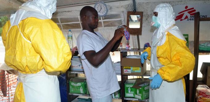   file picture taken on uly 23 2014 shows health workers putting on protective gear at an bola isolation ward in the uinea capital onakry as an outbreak of the disease has so far killed 660 people in west frica 