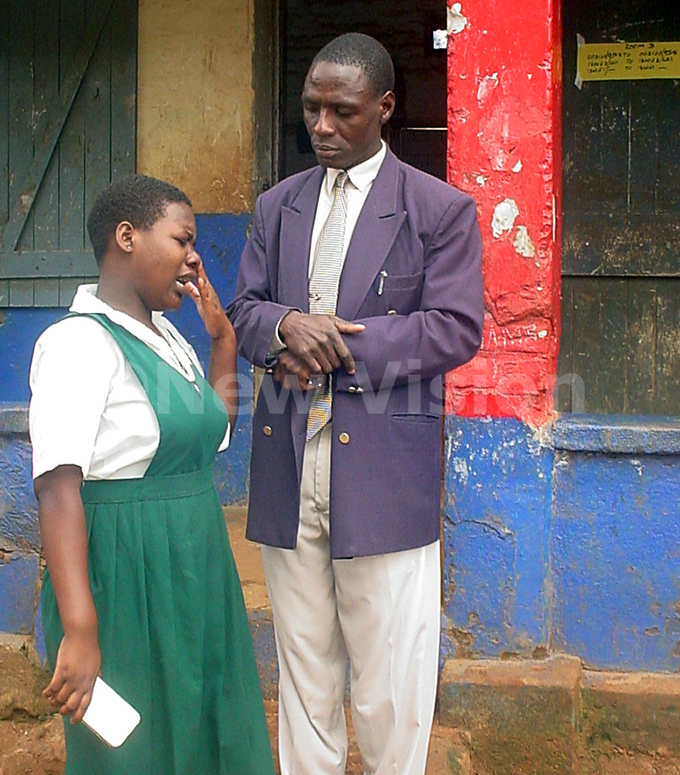   candidate from oly amily rimary school laire amagembe crying before one of the invigilator at awempe uslim rimary school after her head teacher harles uswata allegedly refused her from doing her  exams due un cleared school fees in ovember 2007