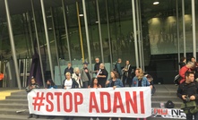 Protesters interrupt Adani speech