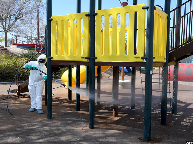   city of as egas operations and maintenance staff worker washes playground equipment at entennial ills ark as part of an effort to keep the citys 70 parks open for the public during the coronavirus pandemic