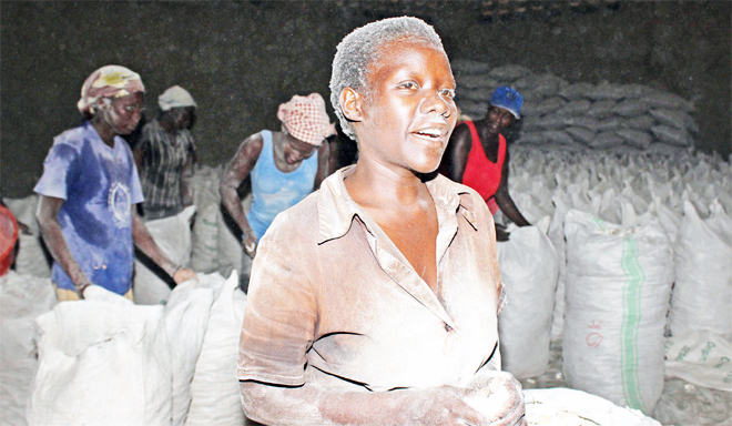  labourer at a cassava grinding mill without protective gear hoto by ony ujuta