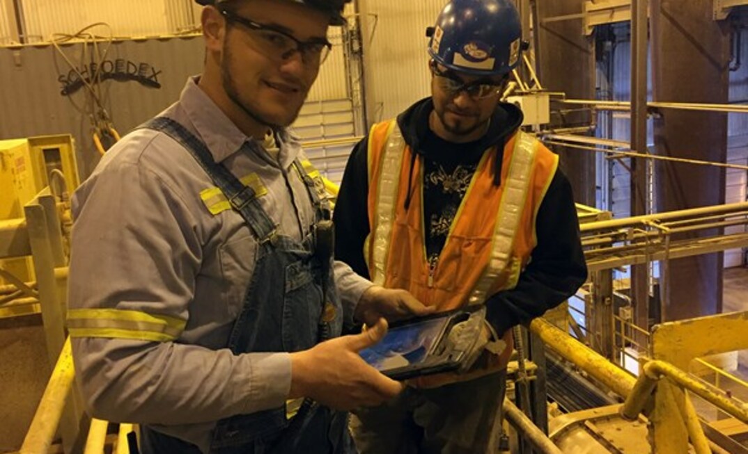 Jordan Stewart, maintenance technician at Cortez, updates a job status on his tablet