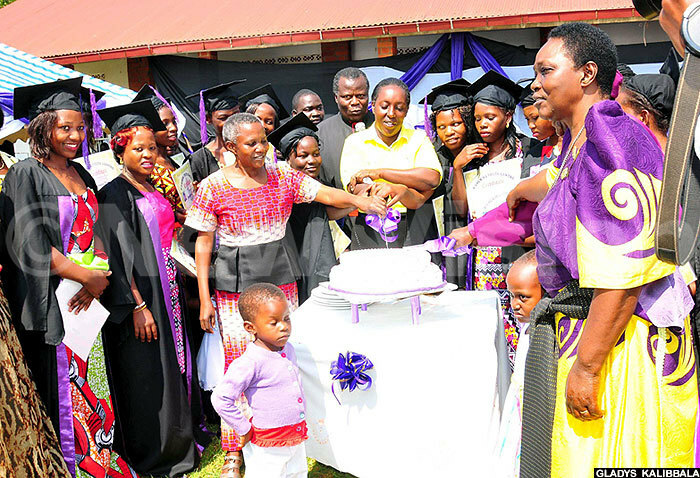  amukisa outh entre graduates and other guests cut a cake during their graduation recently