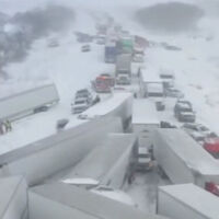 Snowstorm stops traffic on interstate after 100 vehicles collide