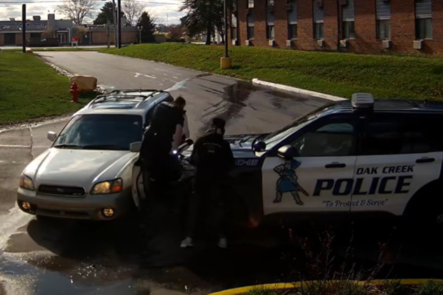 Video- Oak Creek officer pinned between vehicles at motel