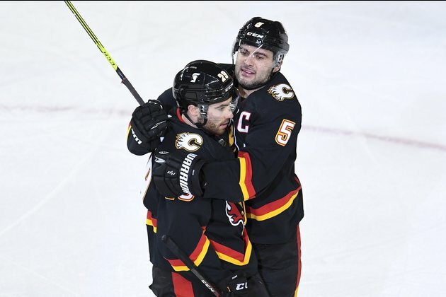NHL roundup: Flames win game, fire coach