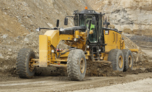 The new Cat 18M3 motor grader blades a pit road