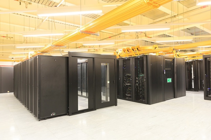 Racks of servers in a brightly lit data centre