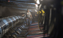 A miner walks under hydraulic jacks next to a coal seam in Foresight Energy's Pond Creek longwall coal mine