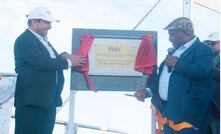 PLC managing director Paul Mulder and PNG PM James Marape cutting the ribbon at the FID announcement.