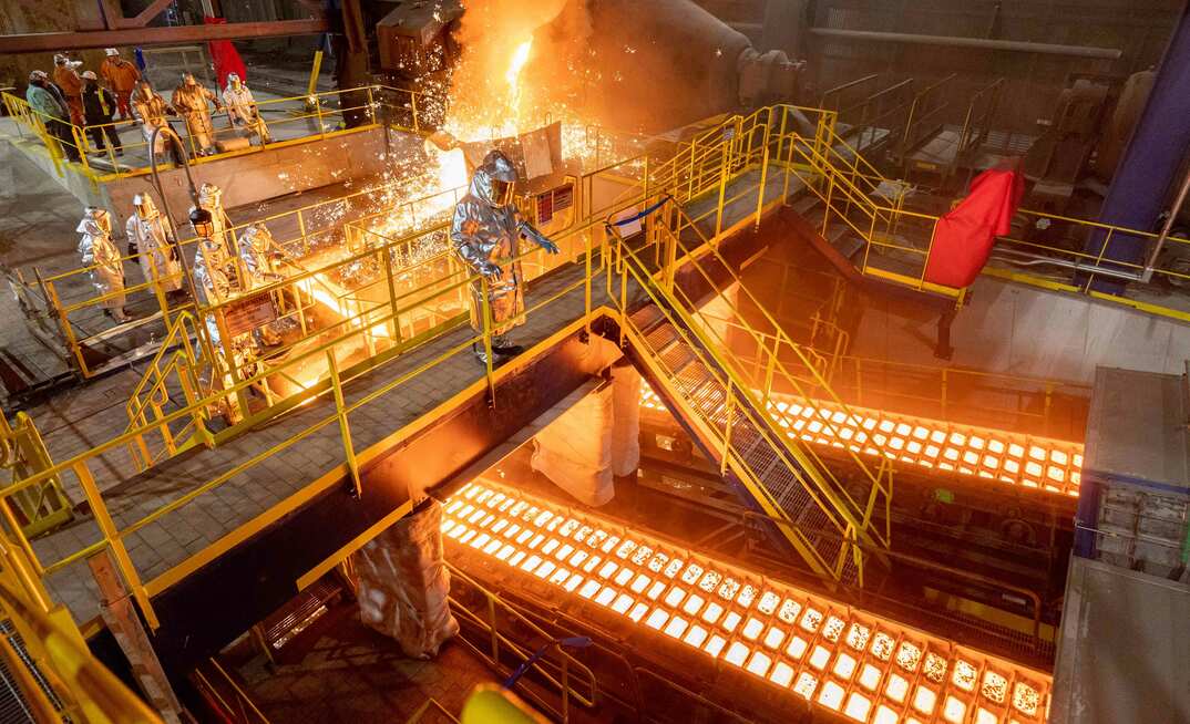 Employees working at the US Steel Gary Works pig iron caster.