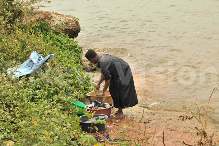   woman washes clothes at the bank of  ictoria at ugula landing site in ukono district 