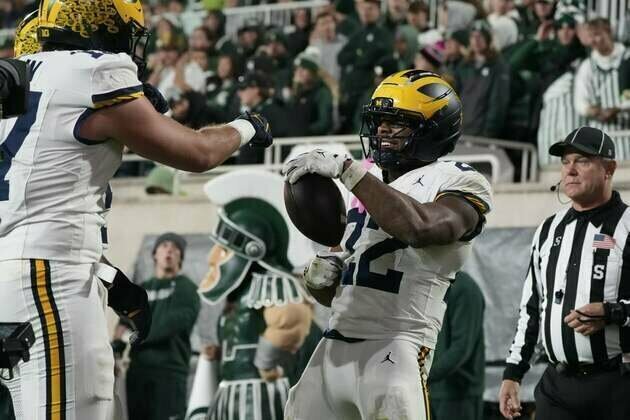 Justice Haynes (2 TDs), carries No. 25 Michigan past Michigan State