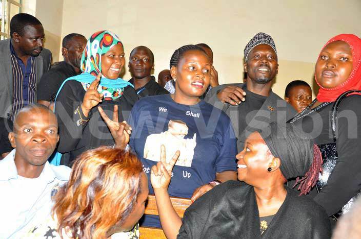   supporters flash party symbol in akindye ourtwho were released on court bail seated right is r tella yanzi hoto by rancis morut