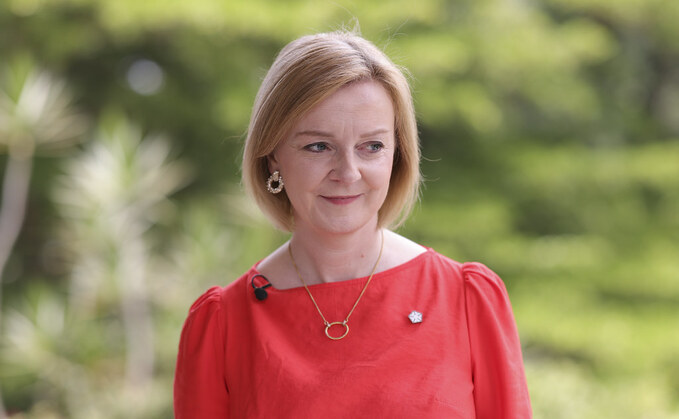 liz truss red dress Liz Truss, then Chief Secretary to the Treasury, walks unrecognised in Westminster in red dress and shoes with matching red-rimmed sunglasses Stock Photo