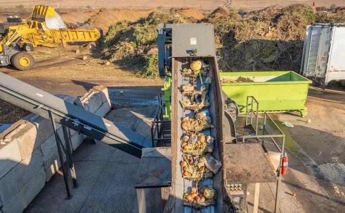 Food enters a Denali depackaging machine, where mechanical processes will separate plastic and cardboard containers from their organic contents / Credit: Denali