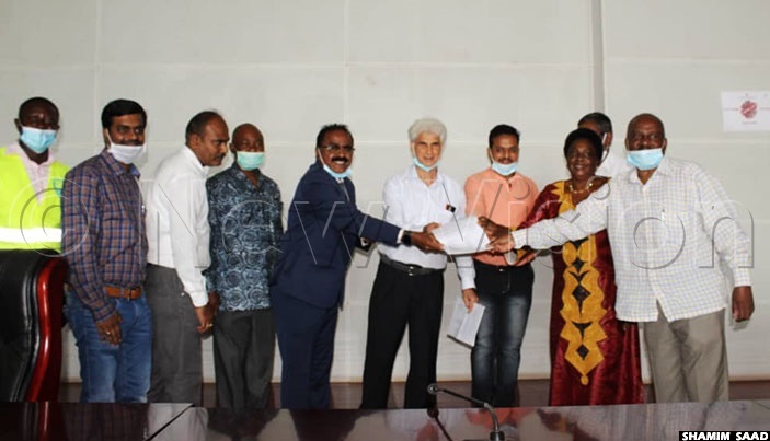   team from ganda rilling ontractors ssociation  hands over an offer letter to the task force to drill 24 boreholes as their contribution towards the 19 emergency response