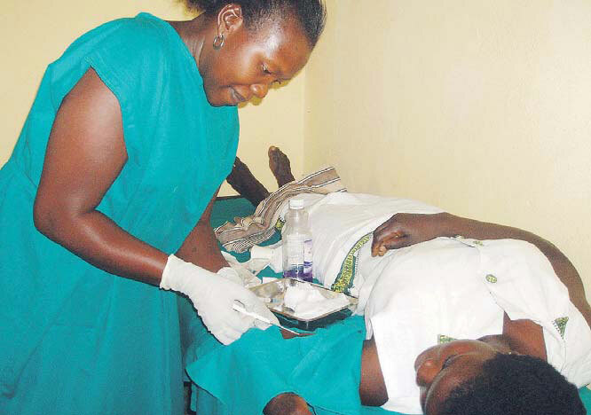  reproductive health worker inserting an implant in a young womans arm