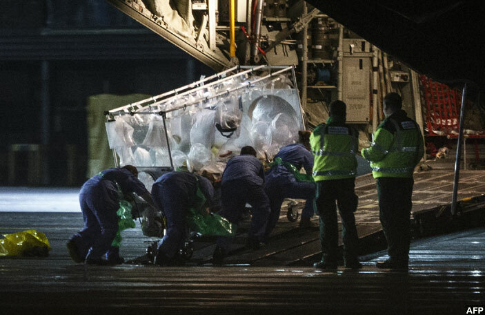  edical personnel wheel a quarantine tent trolley containing cottish healthcare worker auline afferkey who was diagnosed with bola after returning to cotland from ierra eone into a ercules ransport plane at lasgow nternational irport on ecember 30 2014 bound for he oyal ree hospital in ondon