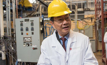  LS Fan holds samples of materials developed in his laboratory that enable clean energy technologies.