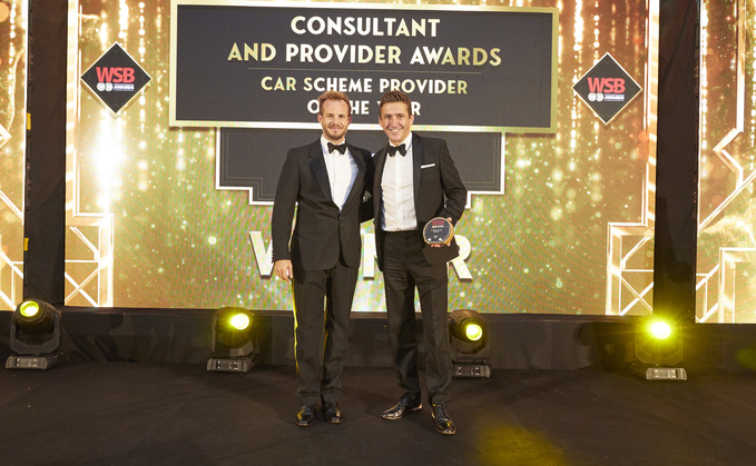 Jimmy McGhie (left) hands the award to Tusker chief executive Paul Gilshan (right)