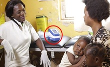 Health workers use the handheld, touch-screen Deki Readers (circled)