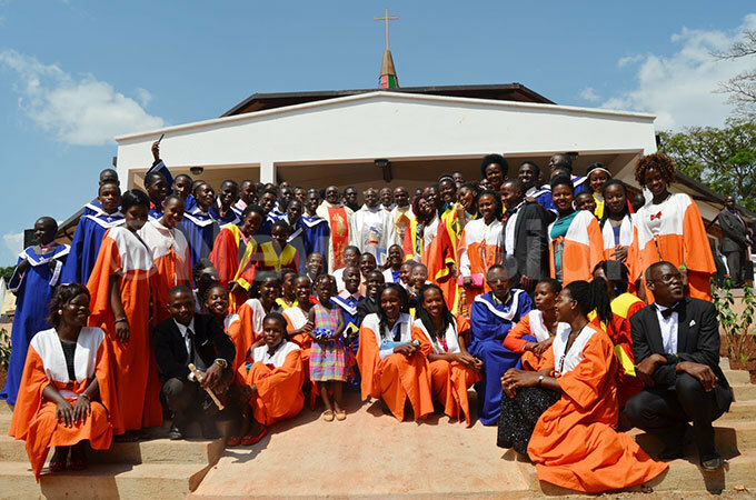 embers of yambogo niversity atholic hapel choirs pose for a photo with the clergy after the function 