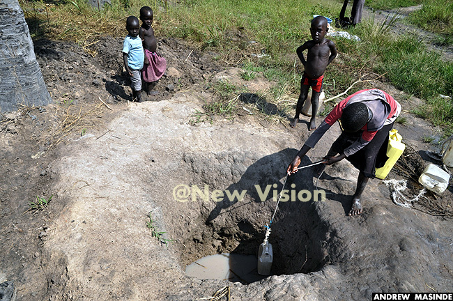  n oyo district chidlren fetching water from a dirty well in alorinya refugee settlement 