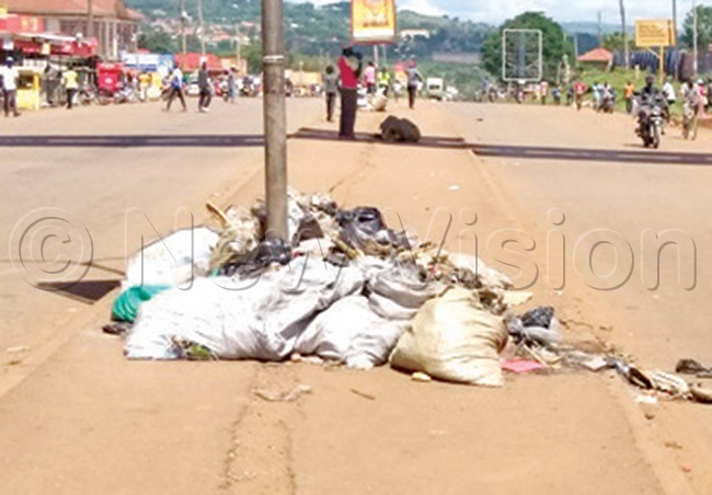 arbage dumped in the road below the ugembe flyover