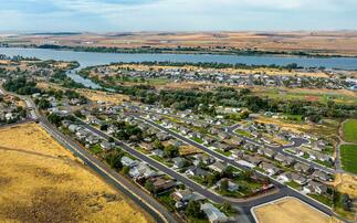 At the confluence of the Umatilla and Columbia rivers in eastern Oregon, water winds through the town of Umatilla's neighborhoods. An irrigation canal is fed by cleansed cooling water straight from a nearby AWS data centre. The water is used to grow the corn, soybeans, and wheat for which the region is famous / Credit: Amazon/Noah Berger
