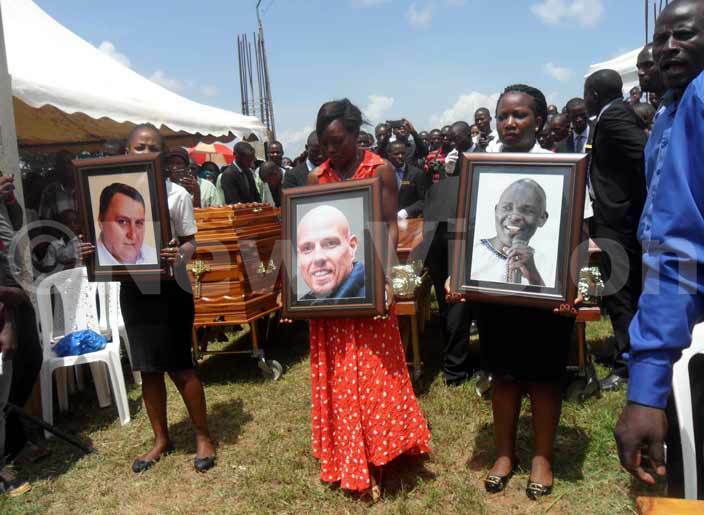  ourners carry portraits of the three pastors who died in an accident unday afternoon