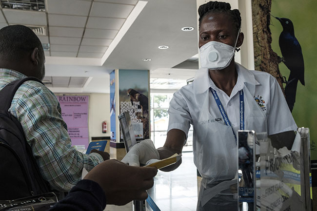  n airport health worker checks travel documents of passengers 