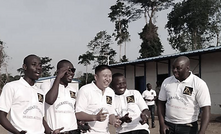 Tietto Minerals' Caigen Wang with Ivorian workers