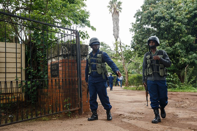 imbabwean policemen outside the home of van awarire  hoto