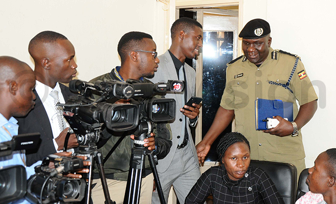 olice spokesperson red nanga shares a light moment with journalists as he arrives for a press briefing at entral olice tation in ampala hoto by amadhan bbey