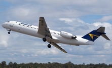 An Alliance Fokker 100 jet taking off.