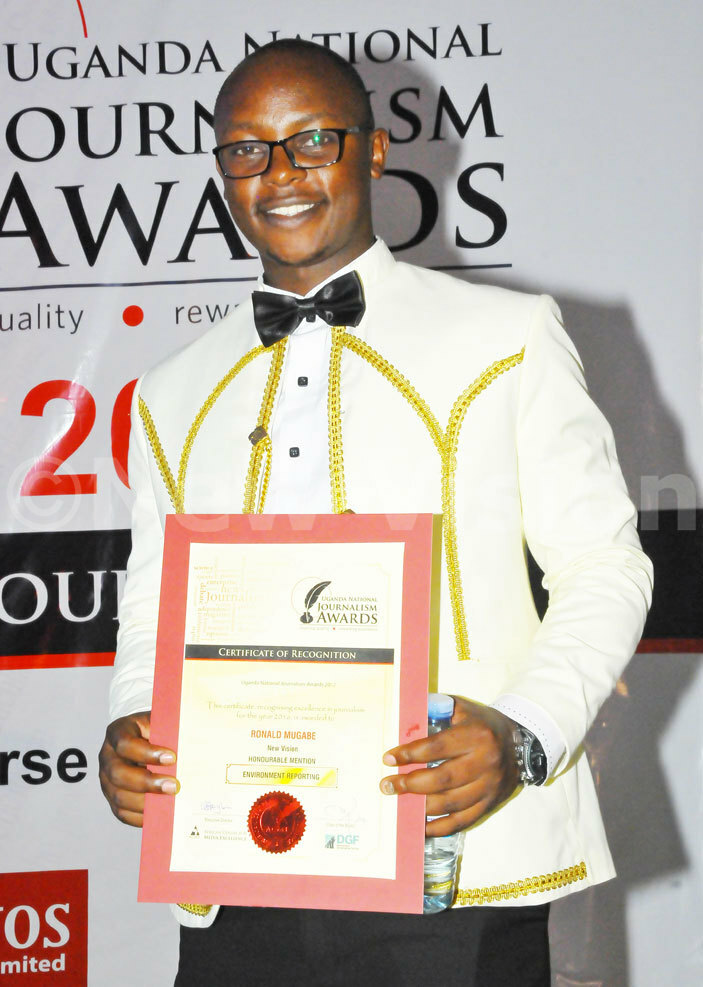  ew isions onald ugabe poses with his certificate of recognition