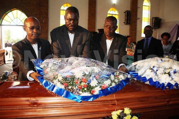  he late uwanguzis siblings lay a wreath on his casket