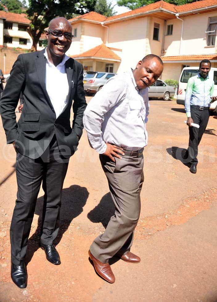  ob asango right cuts a pose with his lawyer arshal lenyo outside court after being granted bail asango was charged with ourt clerk ilton utegeya for conspiring to forge a judicial document in order to steal pension cash amounting to sh154b hoto by enis ibele