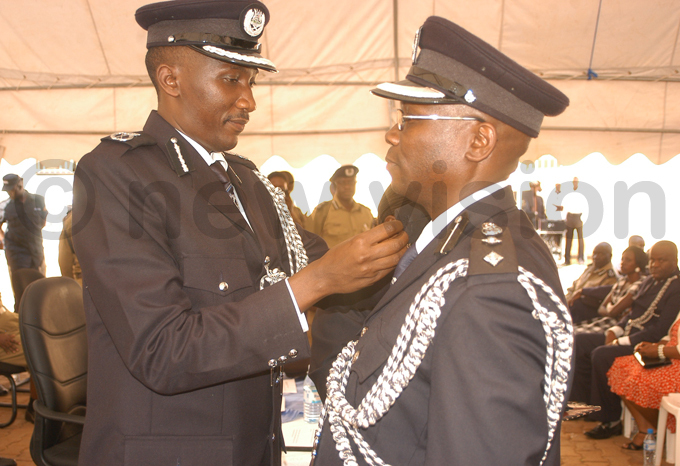 aweesi pipping a fellow olice officer at a ay 2012 ceremony in aguru