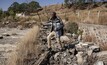 Sibusiso Khumalo from the West End Mining and Rehabilitation Trust walking over the rubble of a home that was demolished at the Waterpan Village.