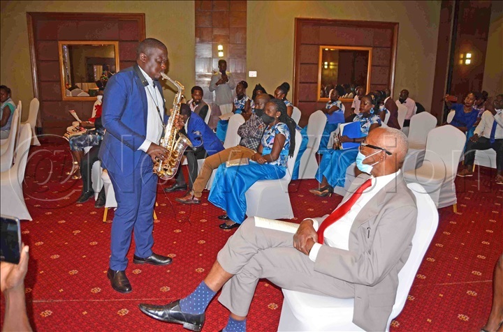 Saxophonist Ategeka playing a Christmas hymn for the audience