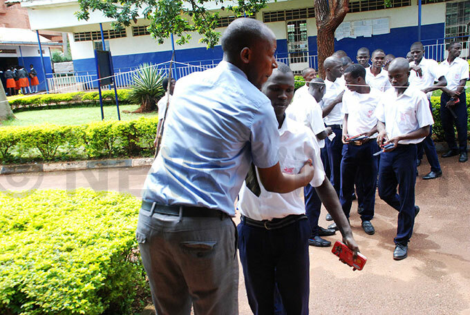   candidate being checked by the invigilator before he enters the examination room for his  examination at ity igh chool in ololo 