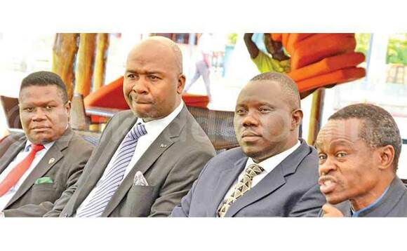 Nobert Mao (ku kkono), Hillary Muguzi (amuddiridde) nga bawuliriza Polof. Lumumba (ayogera). Amuddiridde ye Xavier Enjoyi. Nobert Mao (ku kkono), Hillary Muguzi (amuddiridde) nga bawuliriza Polof. Lumumba (ayogera). Amuddiridde ye Xavier Enjoyi.