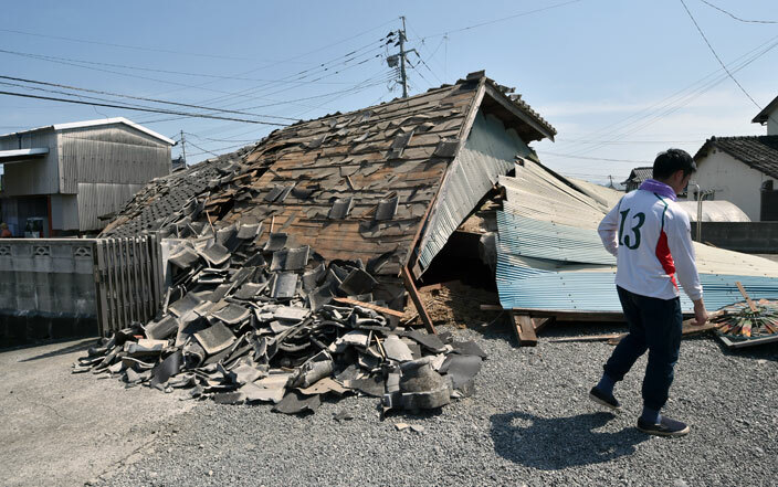  man walks past his collapsed house in the town of ashiki umamoto prefecture on pril 15 2016  
