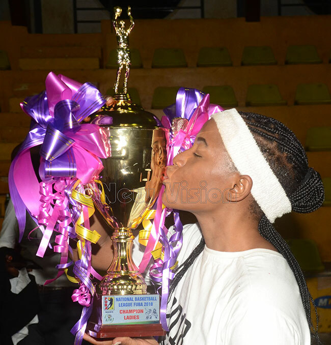   olphins lavia ketcho kisses the usker ite 2018  womens basketball championship trophy at ugogo ctober 24 2018 hoto by ichael subuga