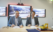 Komatsu's Sean Taylor (left) with Telstra's Martijn Blanken.