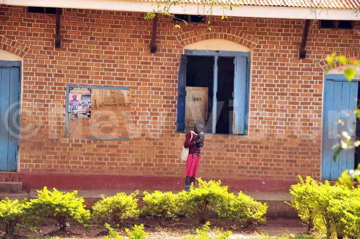   pupil and a parent at ishop entral  after getting information of its closure by the church hoto by enry subuga