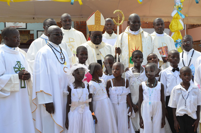  rchbishop wanga with children who received 1st oly ommunion