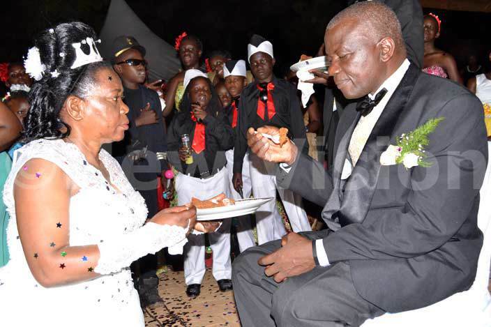  he  couple serves each other at the reception hoto by mos akumbi